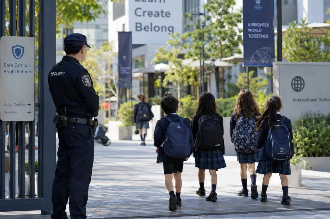 Security officer supervising students on a school campus