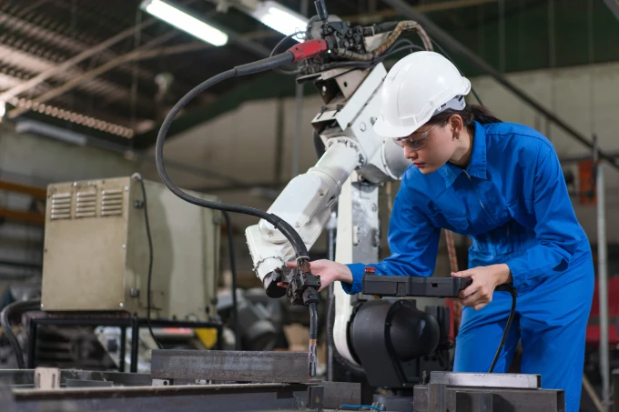 Industrial worker maintaining robotic equipment